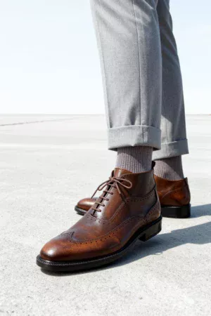 Men's dark brown handcrafted leather brogue boots by Royal Moccs.