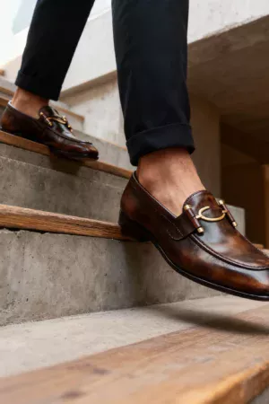 A pair of premium brown leather loafers with a supportive medicated sole for lasting comfort.