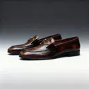 A pair of premium brown leather loafers with a supportive medicated sole for lasting comfort.