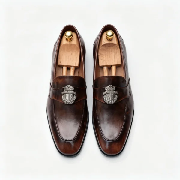 Men's dark brown handcrafted leather loafers with royal crest by Royal Moccs.