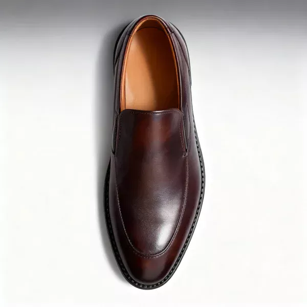 Men's brown handcrafted leather loafers with decorative stitching by Royal Moccs.
