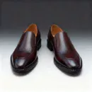 Men's brown handcrafted leather loafers with decorative stitching by Royal Moccs.