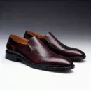 Men's brown handcrafted leather loafers with decorative stitching by Royal Moccs.