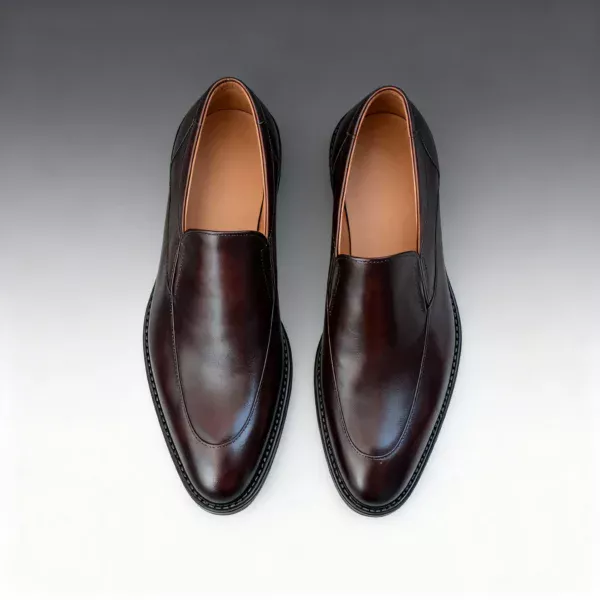 Men's brown handcrafted leather loafers with decorative stitching by Royal Moccs.