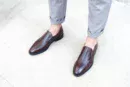Men's brown handcrafted leather loafers with decorative stitching by Royal Moccs.