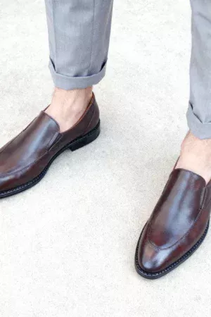 Men's brown handcrafted leather loafers with decorative stitching by Royal Moccs.