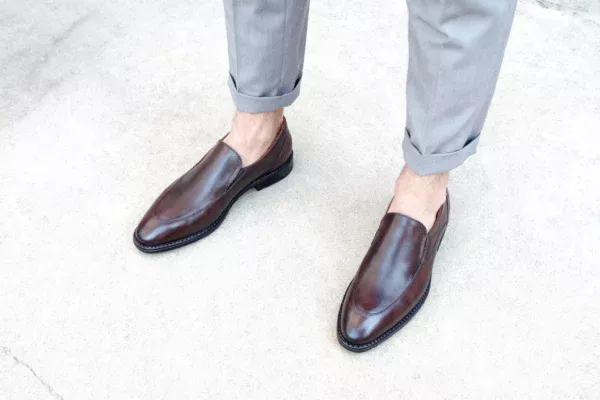 Men's brown handcrafted leather loafers with decorative stitching by Royal Moccs.