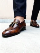 A pair of premium brown leather quilted loafers with a supportive medicated sole for lasting comfort.