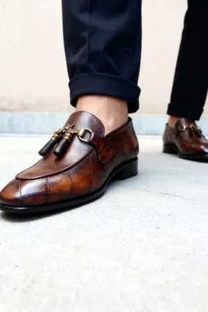 A pair of premium brown leather quilted loafers with a supportive medicated sole for lasting comfort.