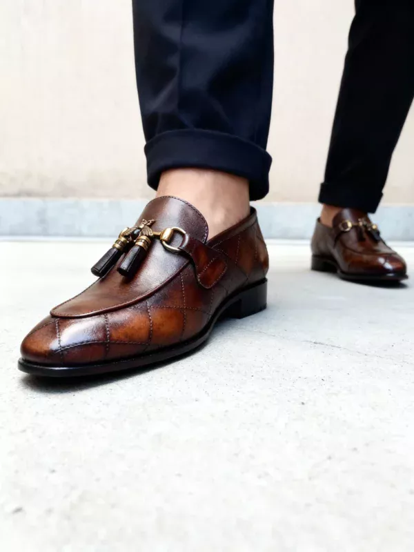 A pair of premium brown leather quilted loafers with a supportive medicated sole for lasting comfort.