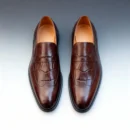 A pair of premium brown leather shoes with a supportive medicated sole for lasting comfort.
