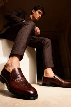 A pair of premium brown leather shoes with a supportive medicated sole for lasting comfort.