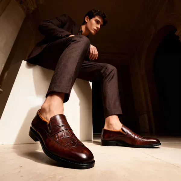 A pair of premium brown leather shoes with a supportive medicated sole for lasting comfort.