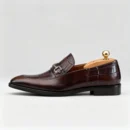 A pair of premium brown leather loafers with an antique gold horsebit and supportive medicated sole.