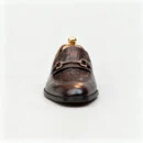 A pair of premium brown leather loafers with an antique gold horsebit and supportive medicated sole.