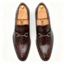 A pair of premium brown leather loafers with an antique gold horsebit and supportive medicated sole.