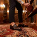 A pair of premium brown leather loafers with an antique gold horsebit and supportive medicated sole.