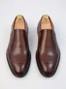 Men's brown handcrafted leather loafers with decorative stitching by Royal Moccs.