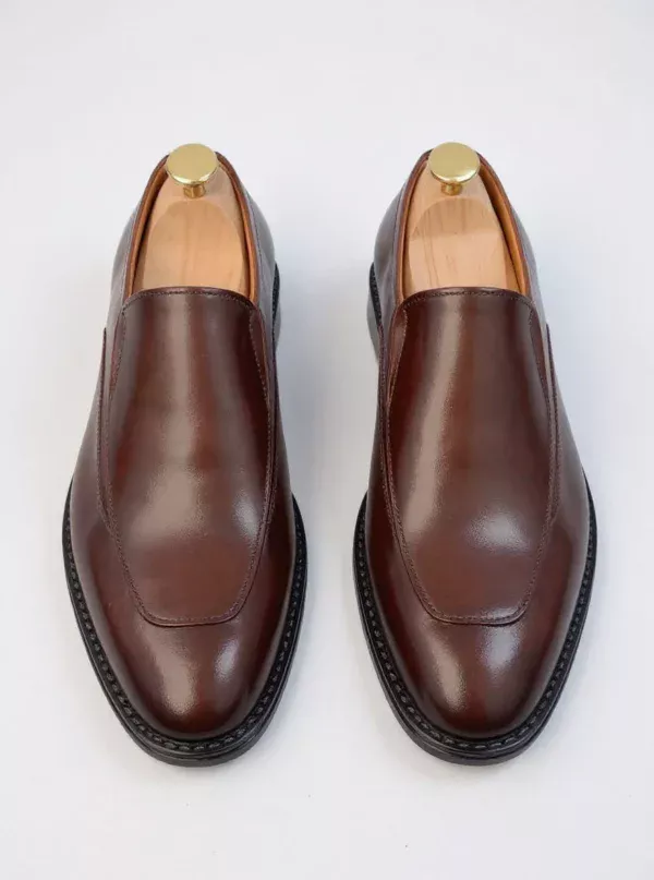 Men's brown handcrafted leather loafers with decorative stitching by Royal Moccs.