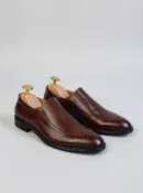 Men's brown handcrafted leather loafers with decorative stitching by Royal Moccs.