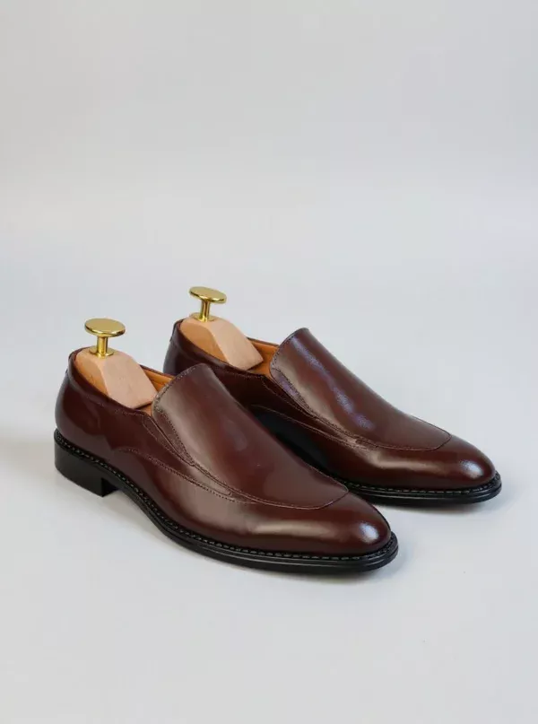 Men's brown handcrafted leather loafers with decorative stitching by Royal Moccs.