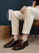 Men's brown handcrafted leather loafers with decorative stitching by Royal Moccs.