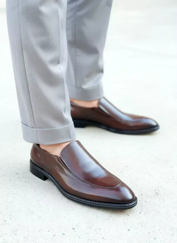 Men's brown handcrafted leather loafers with decorative stitching by Royal Moccs.