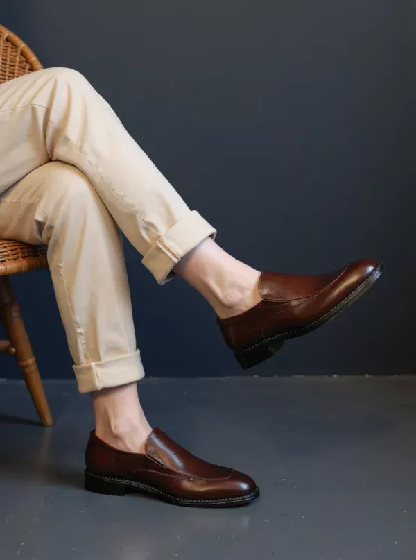 Men's brown handcrafted leather loafers with decorative stitching by Royal Moccs.
