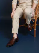 Men's brown handcrafted leather loafers with decorative stitching by Royal Moccs.