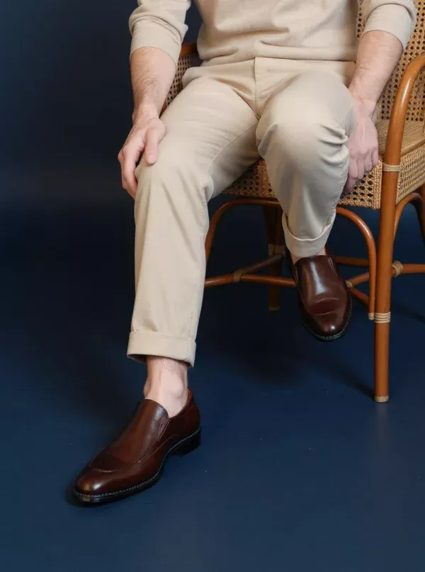 Men's brown handcrafted leather loafers with decorative stitching by Royal Moccs.