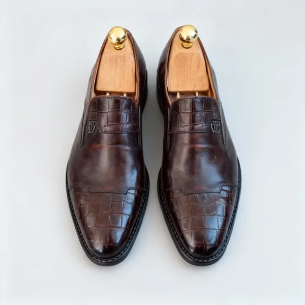 Stylish formal loafers for men with silver insignia, available to buy online in Pakistan.