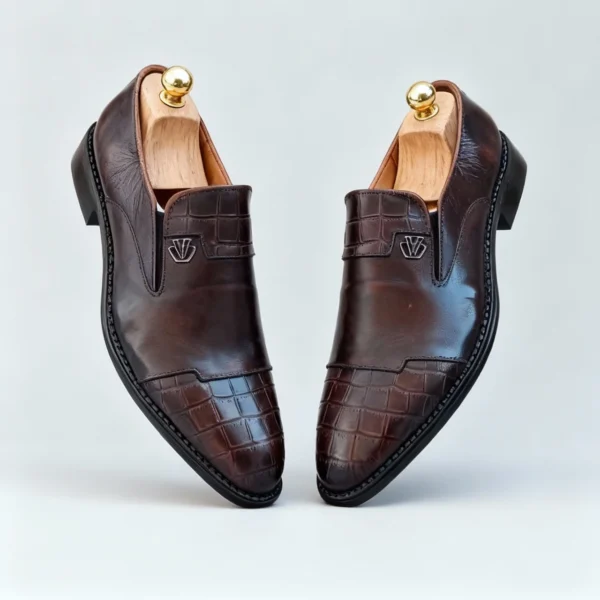 Stylish formal loafers for men with silver insignia, available to buy online in Pakistan.