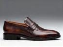 Men's brown handcrafted leather loafers with woven saddle by Royal Moccs.