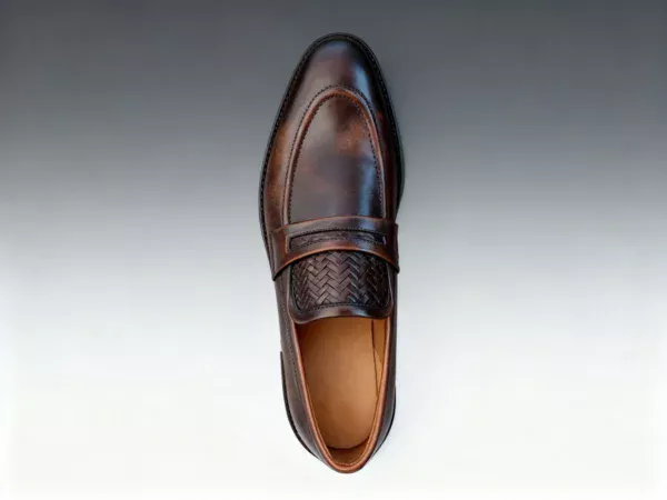 Men's brown handcrafted leather loafers with woven saddle by Royal Moccs.