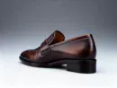 Men's brown handcrafted leather loafers with woven saddle by Royal Moccs.
