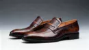 Men's brown handcrafted leather loafers with woven saddle by Royal Moccs.