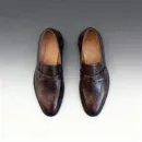 Men's brown handcrafted leather loafers with woven saddle by Royal Moccs.