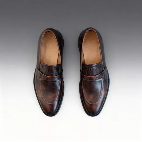 Men's brown handcrafted leather loafers with woven saddle by Royal Moccs.